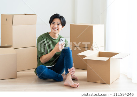 Young man looking at smartphone while moving 111594246
