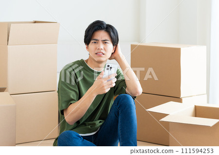 Young man looking at smartphone while moving Young man looking at smartphone while moving 111594253