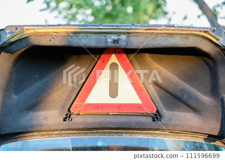 The danger warning sign on the lid of an old car. The concept of replacing a car with a safe one 111596699
