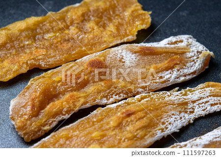 A cooking scene where dried potatoes are fried in a frying pan. A cooking scene where dried potatoes are fried in a frying pan. 111597263