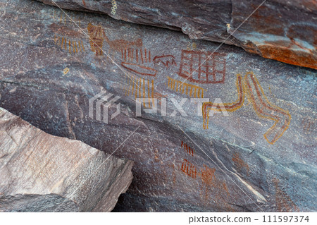 Ancient Petroglyphs Carved on Rocky Surface Revealed 111597374