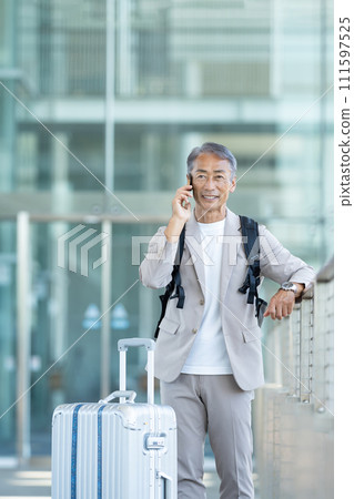 Senior male speaking on smartphone 111597525