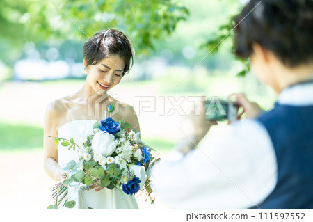 bride and groom taking photos 111597552