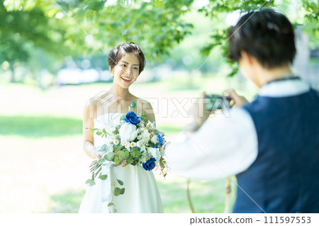 bride and groom taking photos 111597553