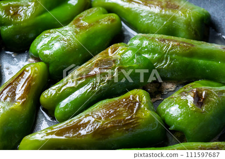 A cooking scene where stuffed peppers are baked in a frying pan. A cooking scene where stuffed peppers are baked in a frying pan. 111597687