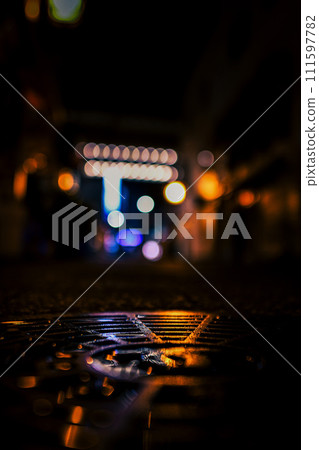 Night view and manhole after rain Night view and manhole after rain 111597782