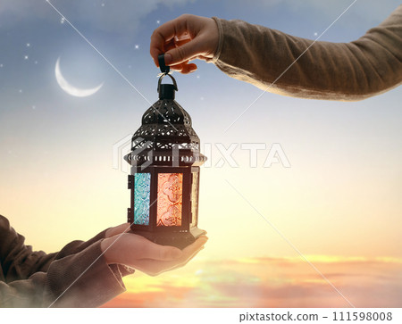 Ornamental Arabic lantern with burning candle Ornamental Arabic lantern with burning candle 111598008