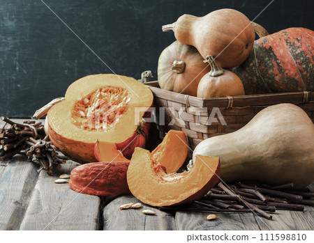 Ripe pumpkins on a wooden table. Ingredients for vegetarian soup. Thanksgiving. Halloween. Ripe pumpkins on a wooden table. Ingredients for vegetarian soup. Thanksgiving. Halloween. 111598810