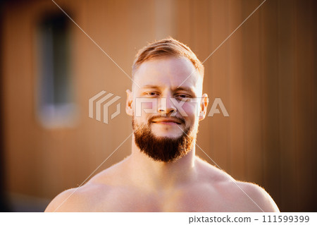 Grinning bearded face of white male in his 30s outdoors. Grinning bearded face of white male in his 30s outdoors. 111599399