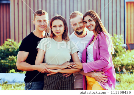 Group portrait of two married couples, young Caucasian spouses p Group portrait of two married couples, young Caucasian spouses p 111599429