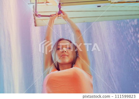 Tightening nut of compression fitting on an external water pipe in country house to eliminate leak, 26 year old European woman is repairing pipeline. Tightening nut of compression fitting on an external water pipe in country house to eliminate leak, 26 year old European woman is repairing pipeline. 111599823