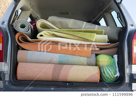 Washed and dried rugs and carpets in the cars trunk 111599896
