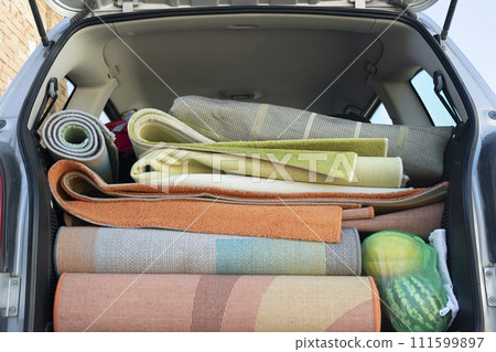 Washed and dried rugs and carpets in the cars trunk 111599897
