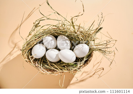 Wicker basket with farm natural white eggs. 111601114