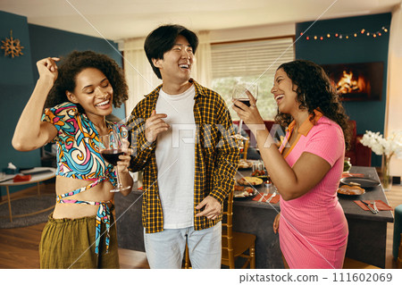 Group of young smiling friends having party and dancing at home. Friendship life style concept Group of young smiling friends having party and dancing at home. Friendship life style concept 111602069