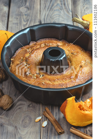 baking background. Bakery. Autumn baking scene , pumpkin pie ingredients on a dark wood background. 111602186