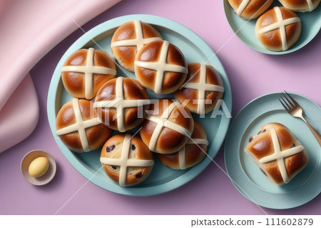 Homemade fresh Easter hot cross buns for easter breakfast on a pastel pink background. Homemade fresh Easter hot cross buns for easter breakfast on a pastel pink background. 111602879