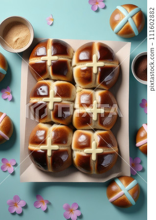Homemade fresh Easter hot cross buns for easter breakfast on a pastel blue background. 111602882