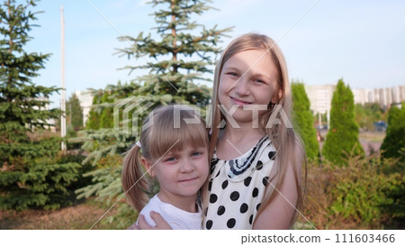 two beautiful little girls portrait in the summer in the park two beautiful little girls portrait in the summer in the park 111603466