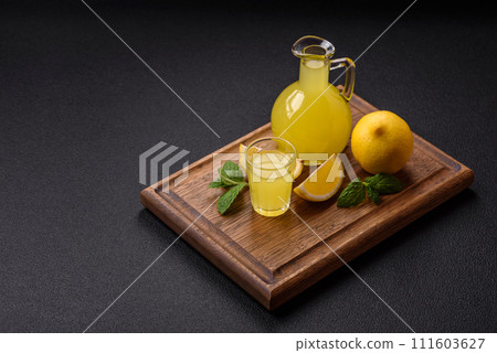 Alcoholic drink yellow limoncello in a small glass 111603627