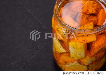 Delicious soft white feta cheese with salt, spices and herbs on a dark concrete background 111603646