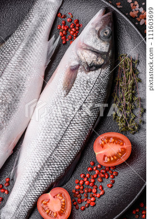Fresh raw ocean sea bass fish with salt, spices and herbs Fresh raw ocean sea bass fish with salt, spices and herbs 111603699
