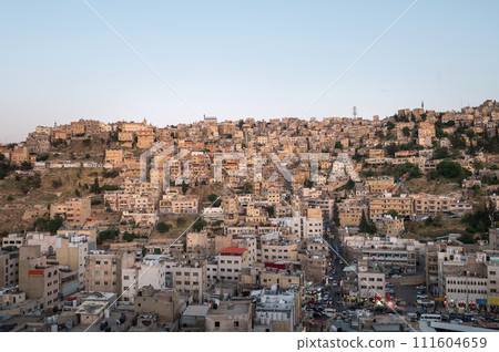 Captivating skyline of Amman, Jordan traditional houses atop a picturesque hill 111604659