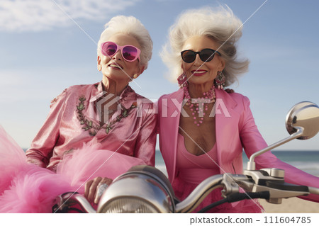 Portrait of an mature couple of women in pink clothes on a motorcycle valentine's Day concept Portrait of an mature couple of women in pink clothes on a motorcycle valentine's Day concept 111604785