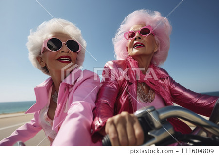 Portrait of an mature couple of women in pink clothes on a motorcycle valentine's Day concept Portrait of an mature couple of women in pink clothes on a motorcycle valentine's Day concept 111604809