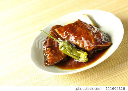 Teriyaki yellowtail with fried shishito and green onion 111604826