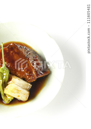 Overhead shot of yellowtail teriyaki and fried shishito and green onions against a white background 111605481