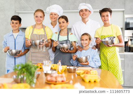 Shot of children participants of culinary master class project and experienced male and female chefs Shot of children participants of culinary master class project and experienced male and female chefs 111605773