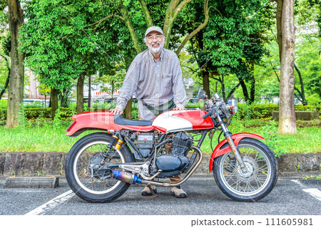 Bike life A smiling senior rider and an old bike 111605981