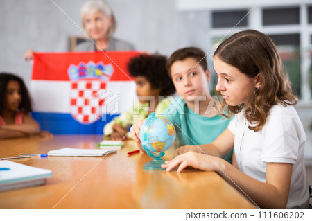 Female teacher showing croatian flag to kids in geography class 111606202