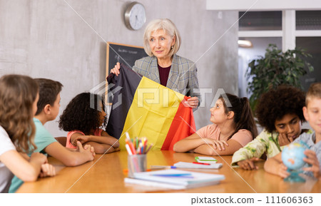 Friendly female teacher tells pupils the history of Belgium 111606363