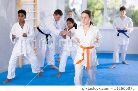 Group of children train karate techniques Group of children train karate techniques 111606873