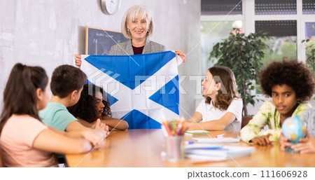 students listen to woman teacher who talks about Scotland students listen to woman teacher who talks about Scotland 111606928