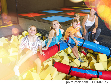 Children rest after intdoor activities in amusement park 111607147