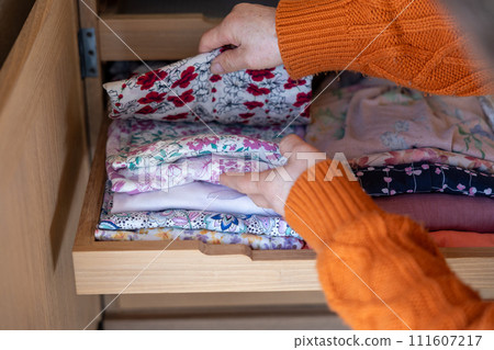 Hands of a senior woman organizing her clothes 111607217