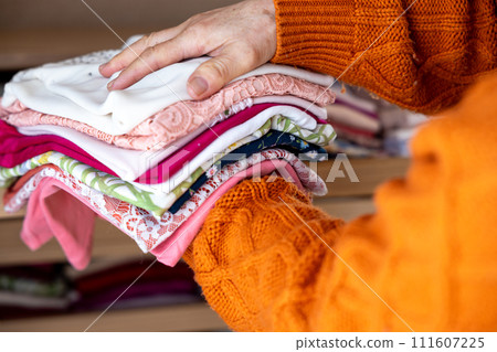 Hands of a senior woman organizing her clothes Hands of a senior woman organizing her clothes 111607225