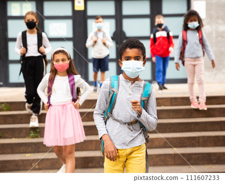 African american tween schoolboy in protective mask going to school African american tween schoolboy in protective mask going to school 111607233