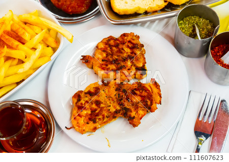 Turkish chicken chops prepared on mangal with fried potatoes 111607623