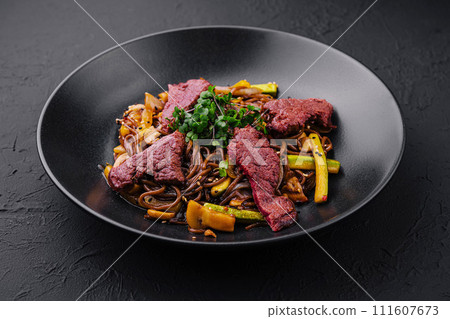 Chinese fried rice with beef on black plate Chinese fried rice with beef on black plate 111607673