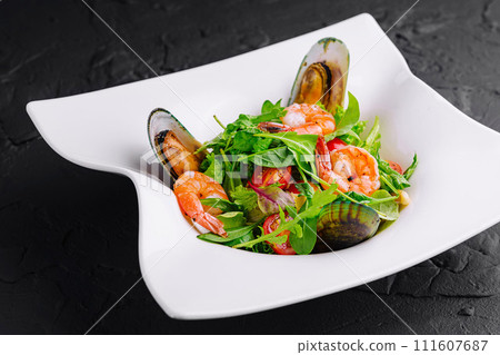 Seafood salad with shrimps and mussels on plate 111607687