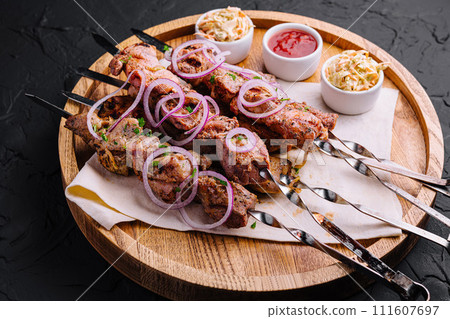 kebabs from pork on skewers on wooden board kebabs from pork on skewers on wooden board 111607697