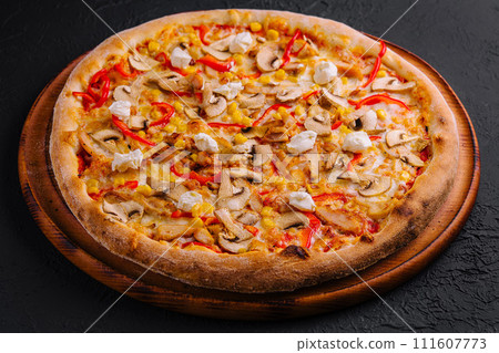 pizza with bell peppers, corn, meat and mushrooms on wooden board pizza with bell peppers, corn, meat and mushrooms on wooden board 111607773