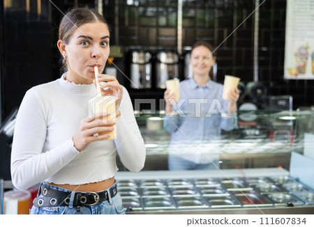Young girl savoring taste of popular Taiwanese refreshing bubble tea 111607834