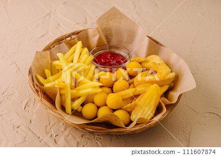 Different types of fried potatoes, such as french fries, roast potatoes and potato balls 111607874