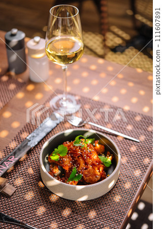 Gourmet fried squid Yakuza and sesame and glass of wine 111607891