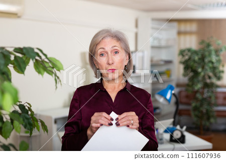 Portrait of pensive business woman with documents in office Portrait of pensive business woman with documents in office 111607936